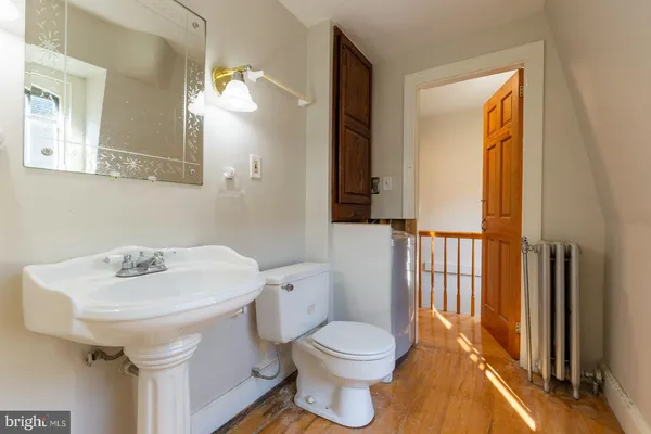 a bathroom with a sink a toilet and mirror