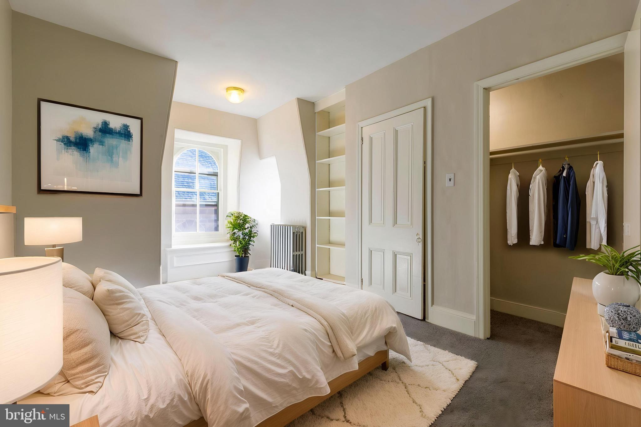 3604 Baring Street, Unit 2 Philadelphia, PA 19104 - Photo 10 of 25 a bedroom with a bed and a painting on the wall