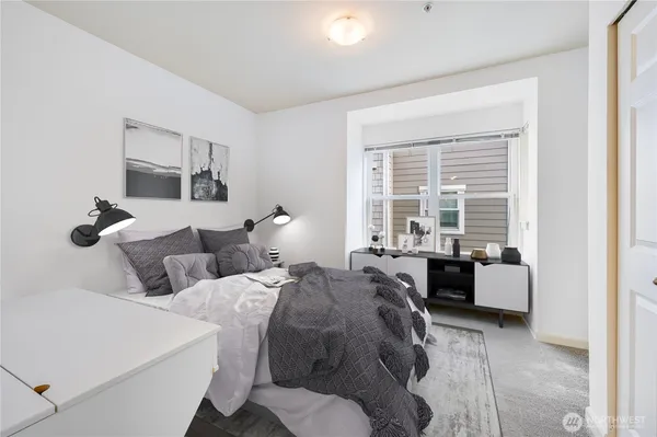 a bed room with bed and a large window
