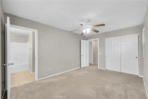 a view of an empty room with a ceiling fan