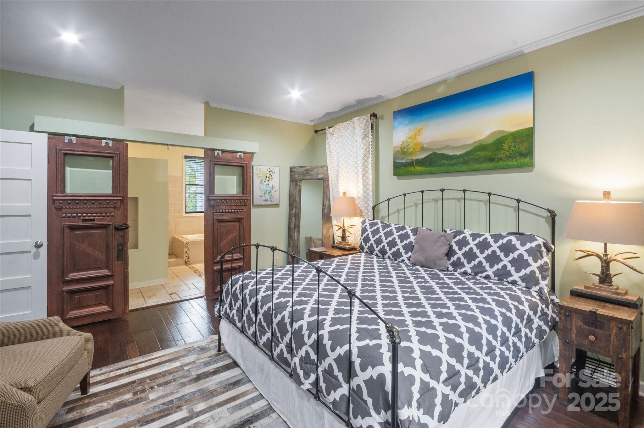 94 Davey Crockett Road Fairview, NC 28730 - Photo 11 of 41 a bedroom with a large bed and a flat tv screen on dresser