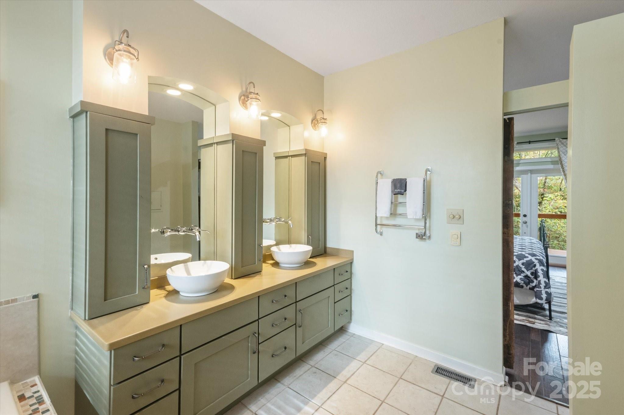 94 Davey Crockett Road Fairview, NC 28730 - Photo 14 of 41 a bathroom with a double vanity sink mirror and double