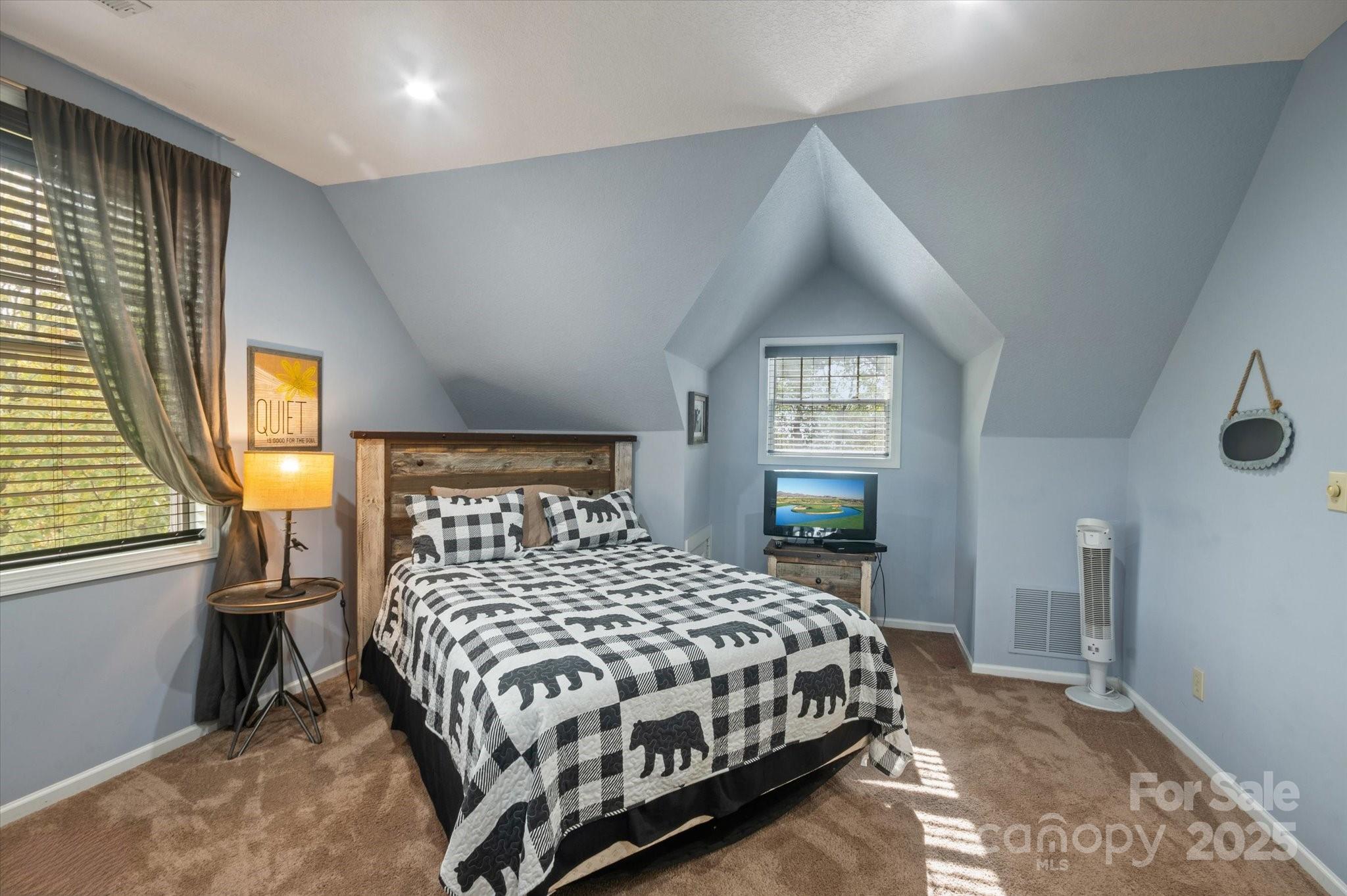 94 Davey Crockett Road Fairview, NC 28730 - Photo 21 of 41 a bedroom with a bed and window