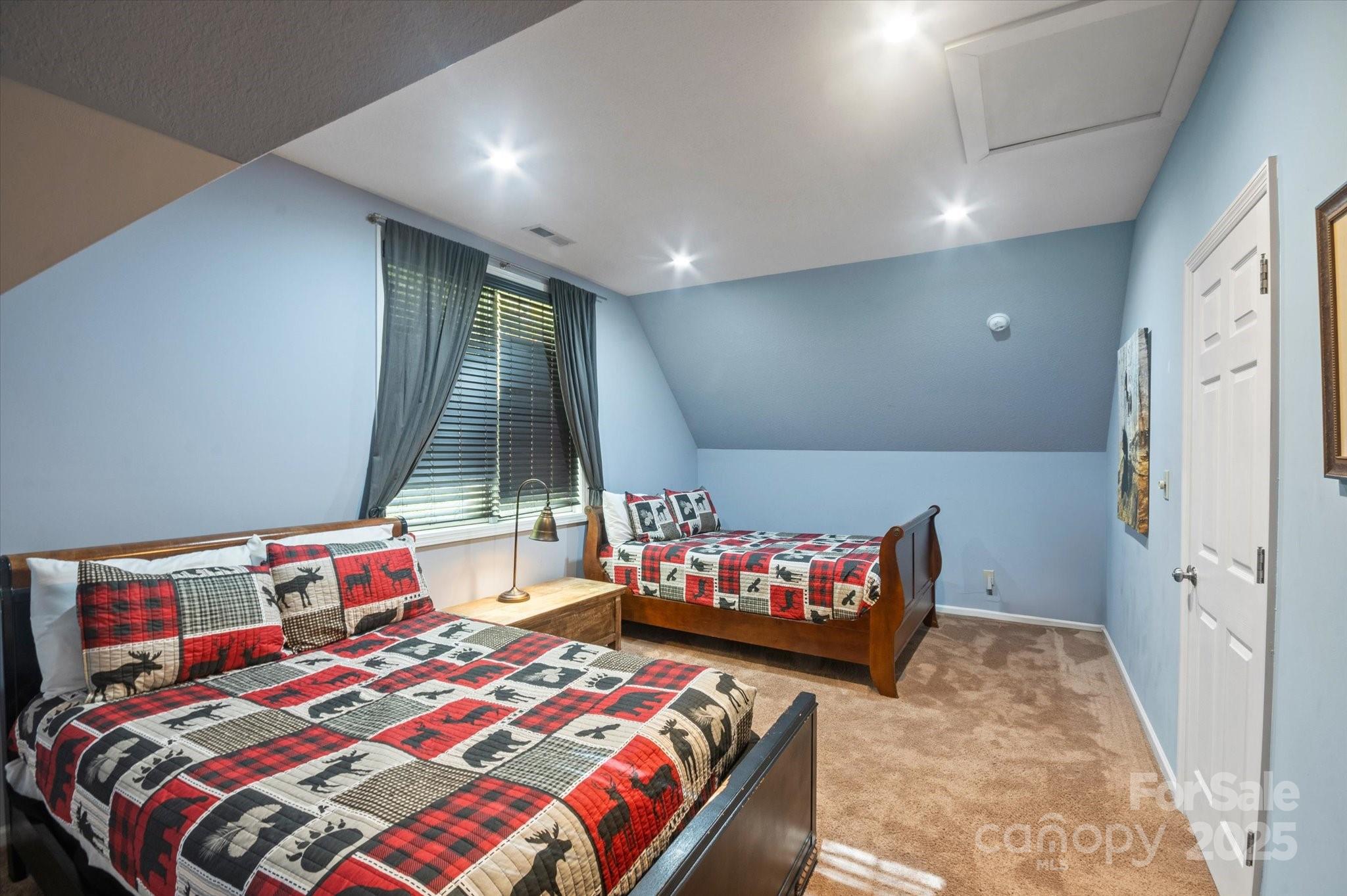 94 Davey Crockett Road Fairview, NC 28730 - Photo 25 of 41 a bedroom with a bed and a couch