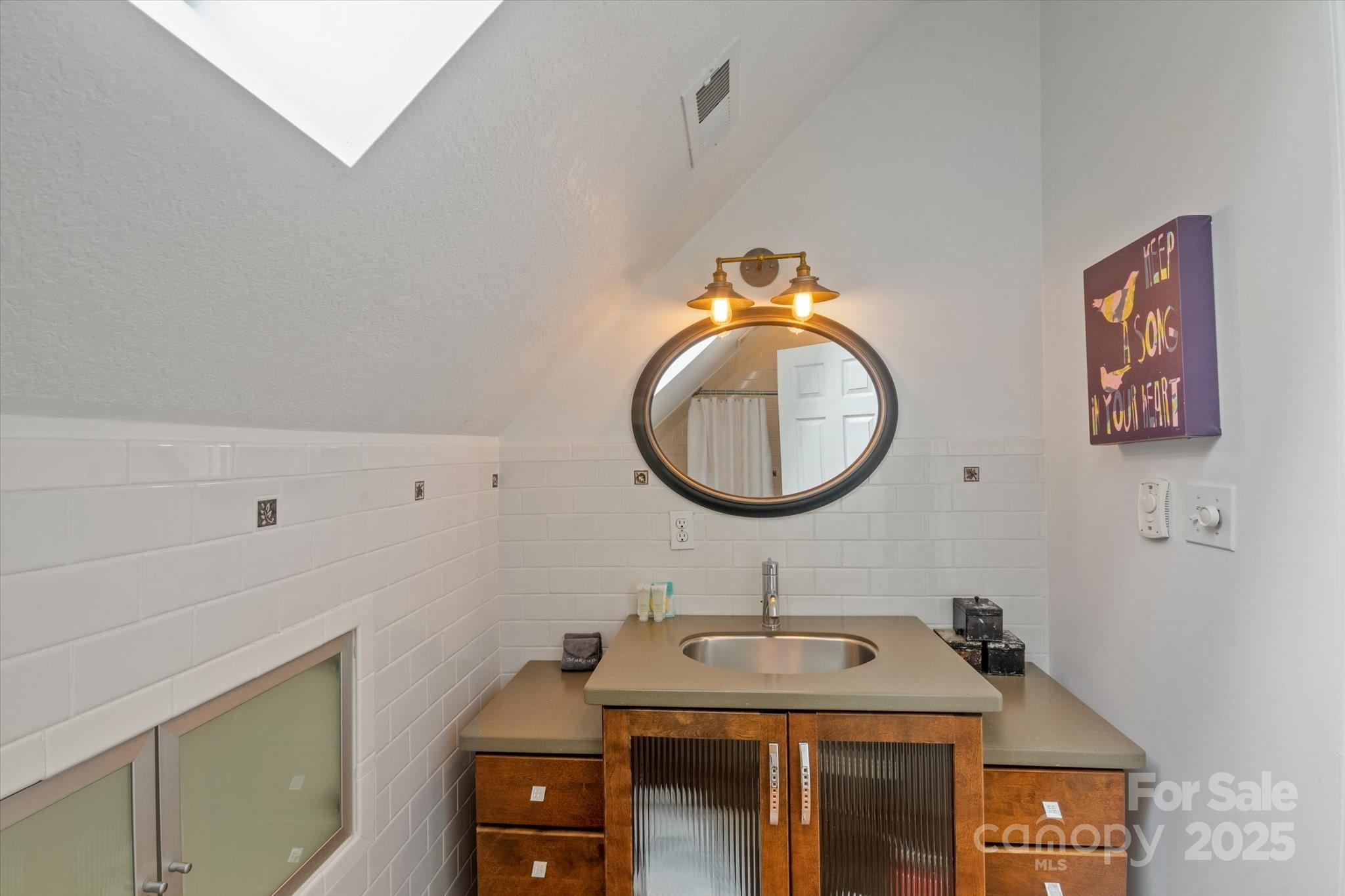 94 Davey Crockett Road Fairview, NC 28730 - Photo 26 of 41 a bathroom with a sink and a mirror
