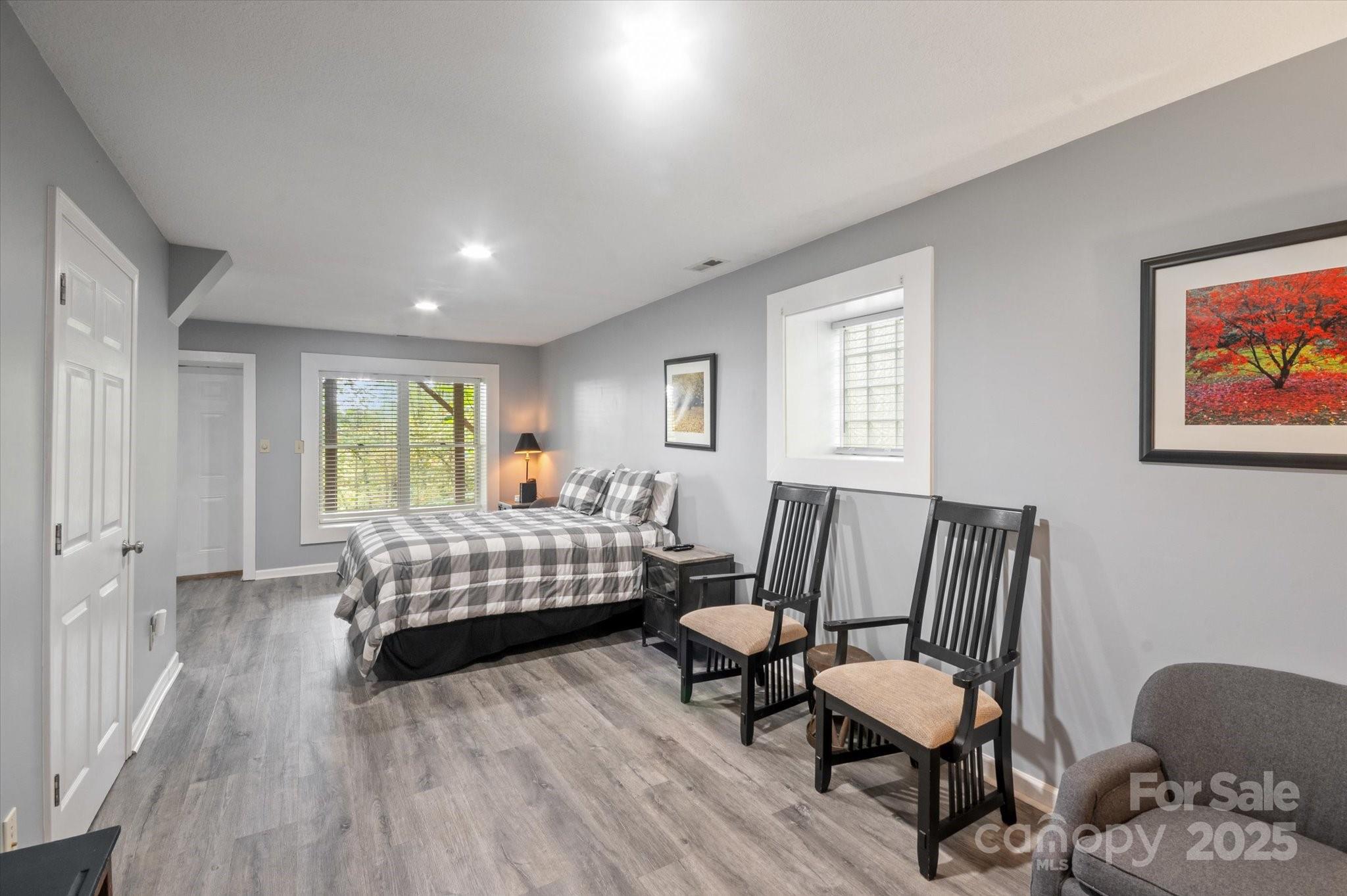 94 Davey Crockett Road Fairview, NC 28730 - Photo 28 of 41 a bedroom with furniture and wooden floor