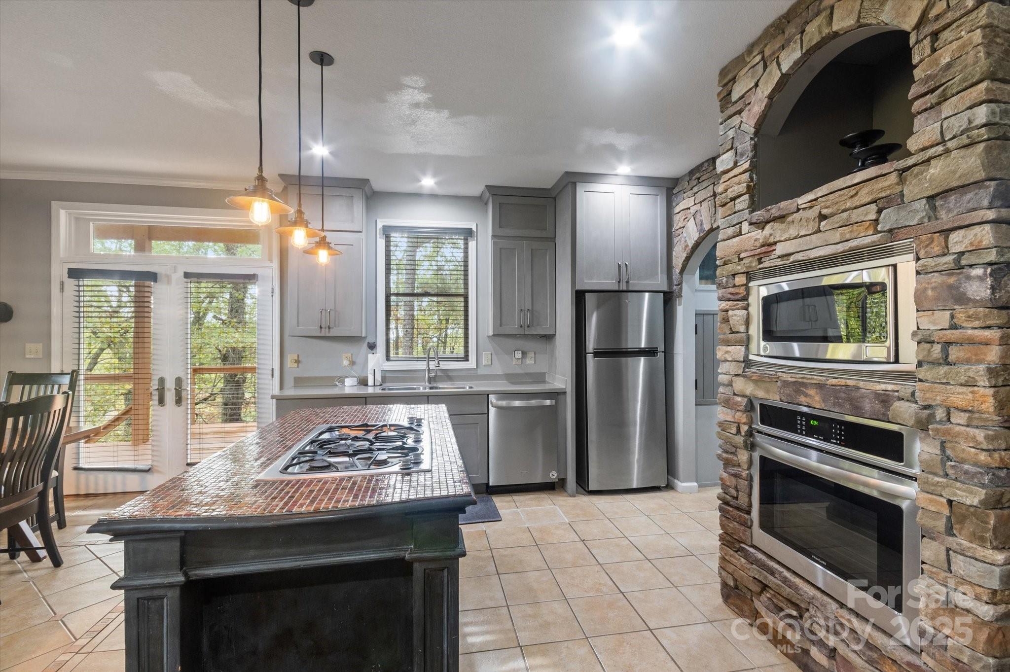 94 Davey Crockett Road Fairview, NC 28730 - Photo 7 of 41 a kitchen with a sink stove and refrigerator