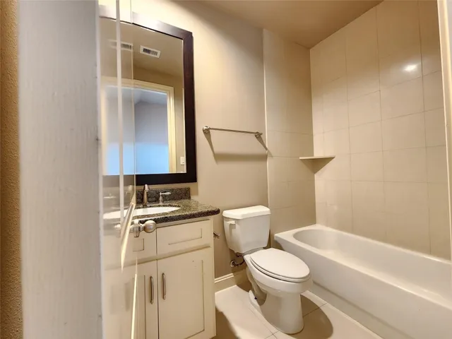 a white toilet sitting next to a bathroom sink
