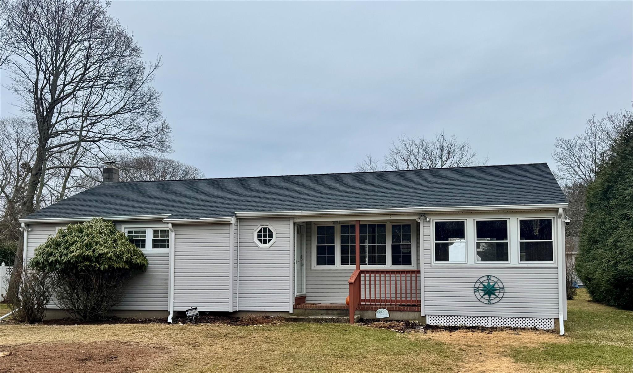 220 Fiddler Lane Greenport, NY 11944 - Photo 1 of 21 View of front facade featuring a shingled roof and a front yard