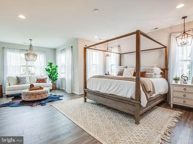 a bedroom with a bed couch and a window