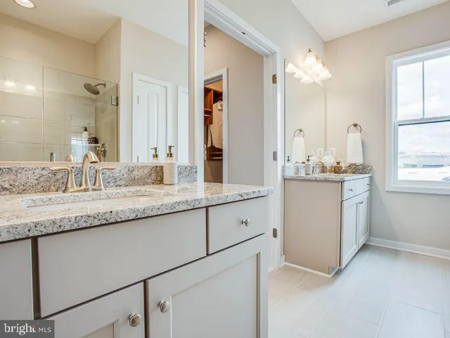 a bathroom with a sink double vanity and a mirror