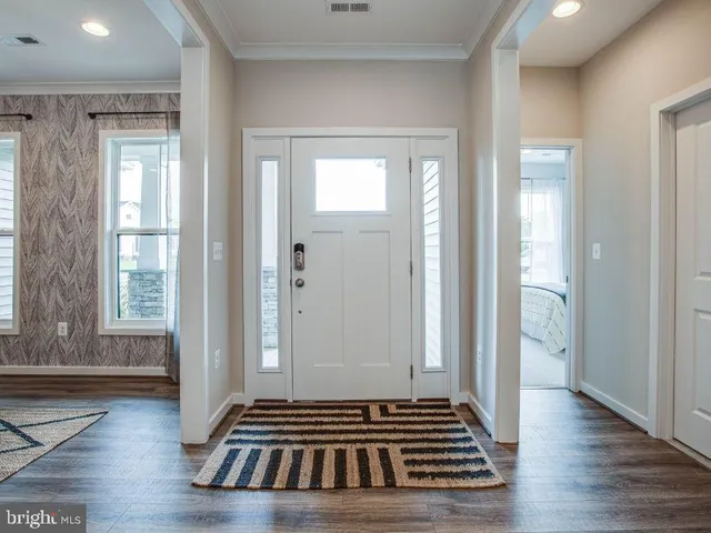 a view of a livingroom with wooden floor and a window