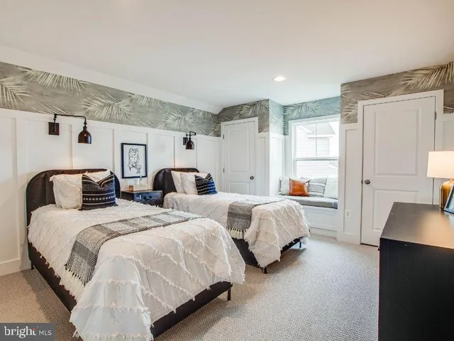 a spacious bedroom with two beds and a couch