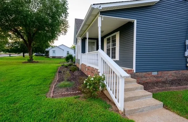 a front view of house with yard and green space