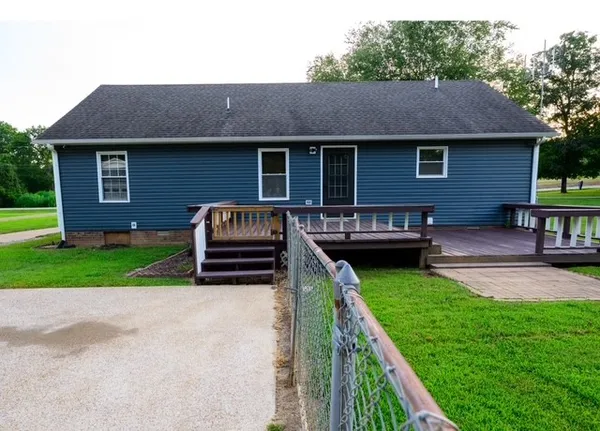 a house view with a seating space and garden