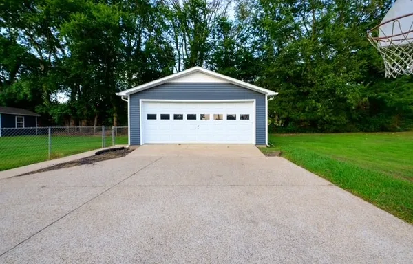 a house with green field in front of it