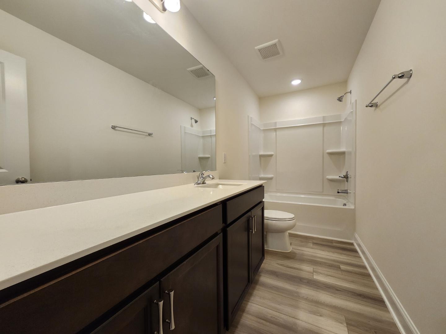 1224 Weavers Trce Drive Zebulon, NC 27597 - Photo 17 of 21 a bathroom with a sink a toilet and shower