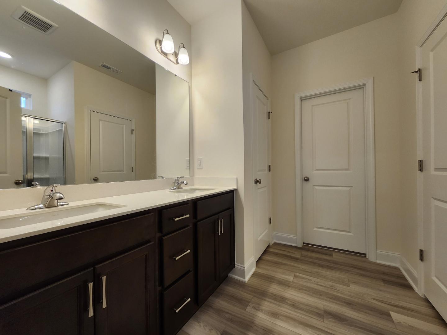 1224 Weavers Trce Drive Zebulon, NC 27597 - Photo 8 of 21 a bathroom with a double vanity sink and mirror