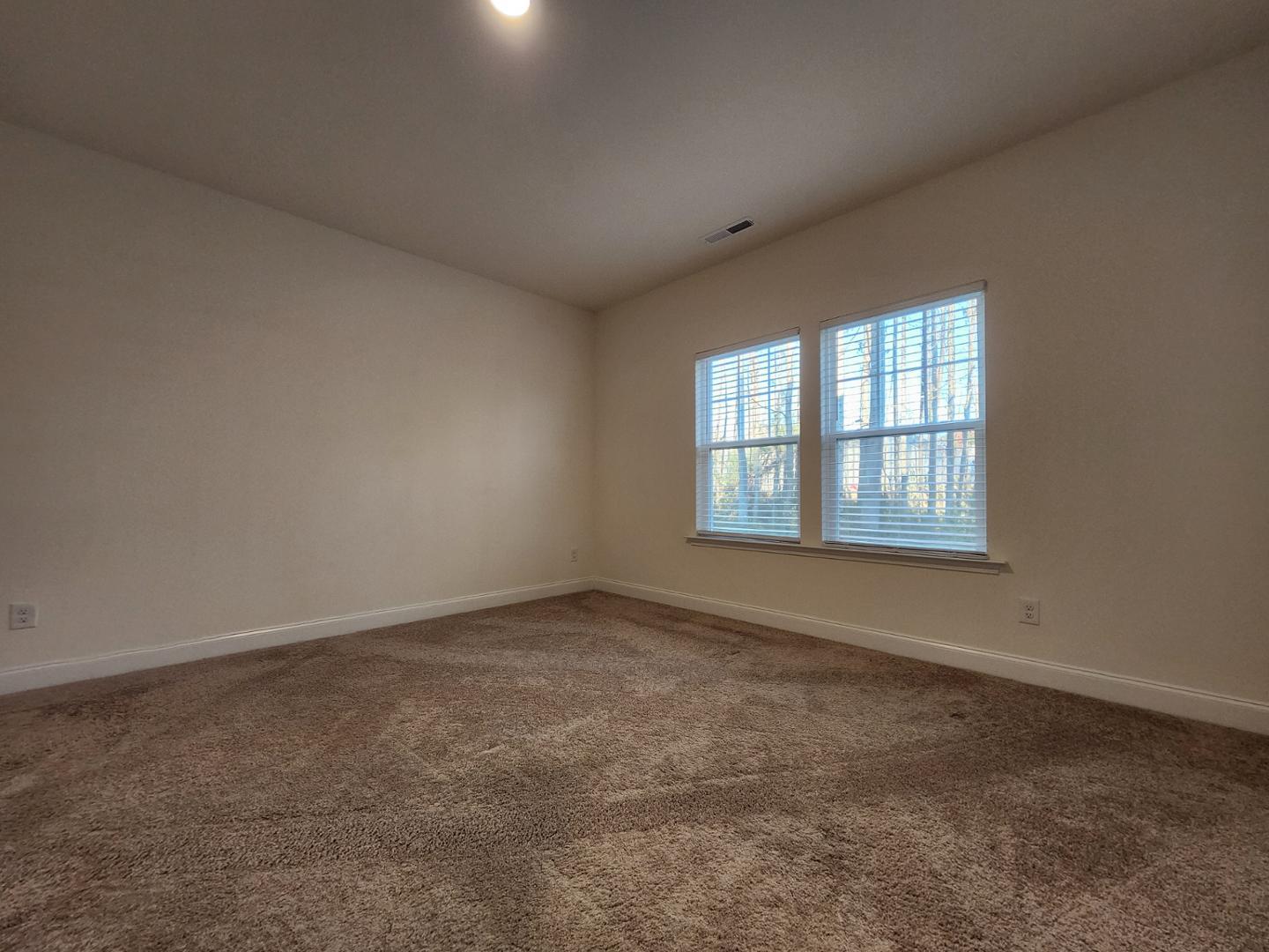 1224 Weavers Trce Drive Zebulon, NC 27597 - Photo 9 of 21 an empty room with windows