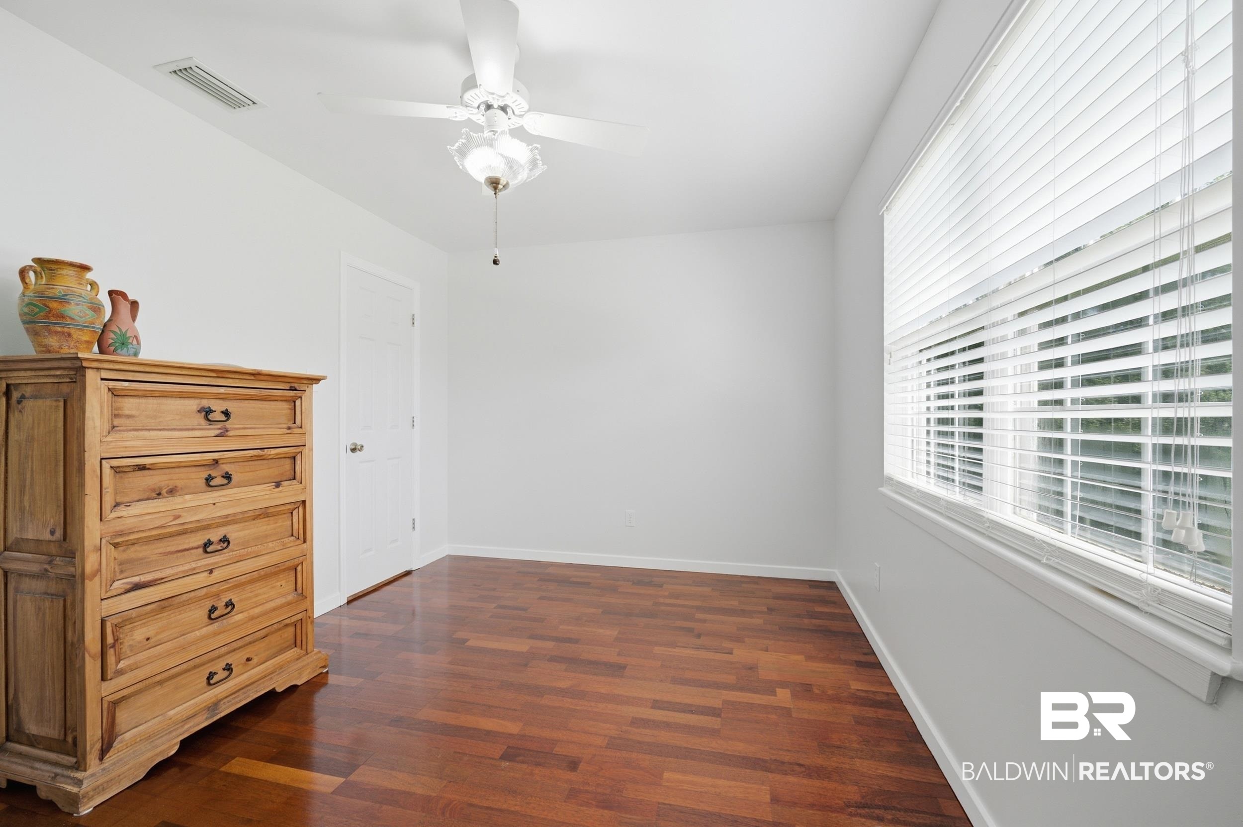 15855 Calvin Richerson Road Bay Minette, AL 36507 - Photo 51 of 83 Bright room featuring wood-finish flooring, a white ceiling fan with integrated lighting, and a window with horizontal blinds
