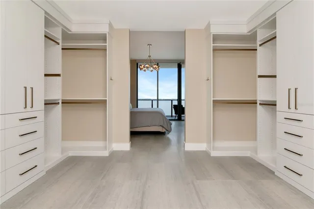 a kitchen with a sink a refrigerator and chairs