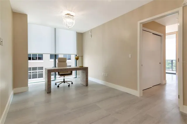 a living room with furniture and large windows