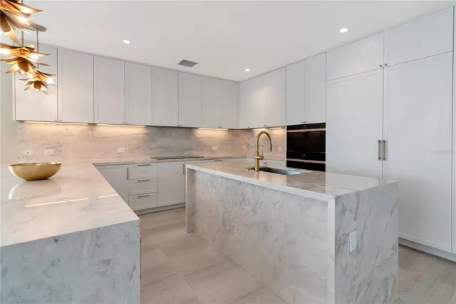 a bed room with a bed and a chandelier