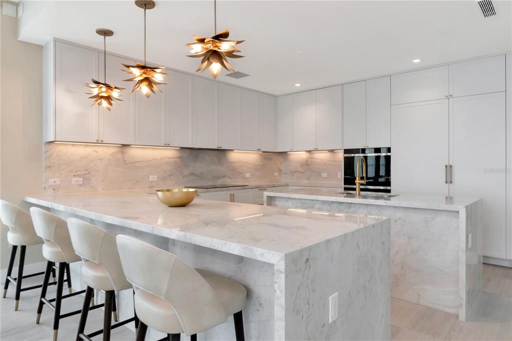 2912 West Santiago Street, Unit 804 Tampa, FL 33629 - Photo 31 of 95 a kitchen with a sink a refrigerator and chairs