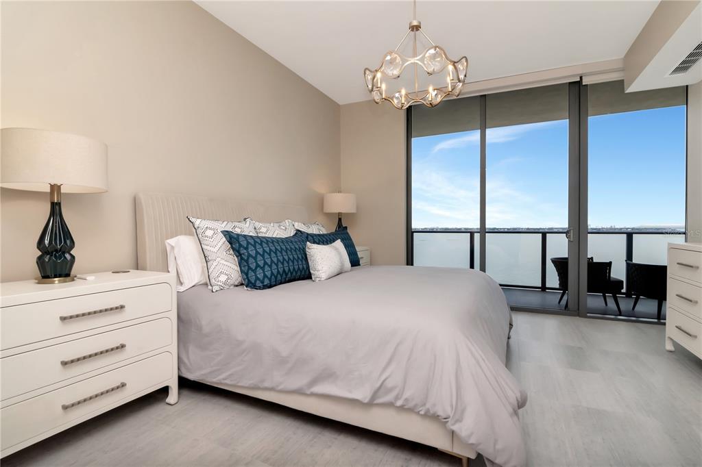 2912 West Santiago Street, Unit 804 Tampa, FL 33629 - Photo 6 of 95 a bedroom with a large bed and a chandelier