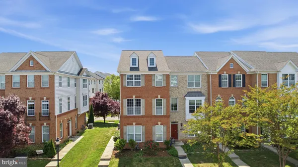 a front view of a residential apartment building with a yard