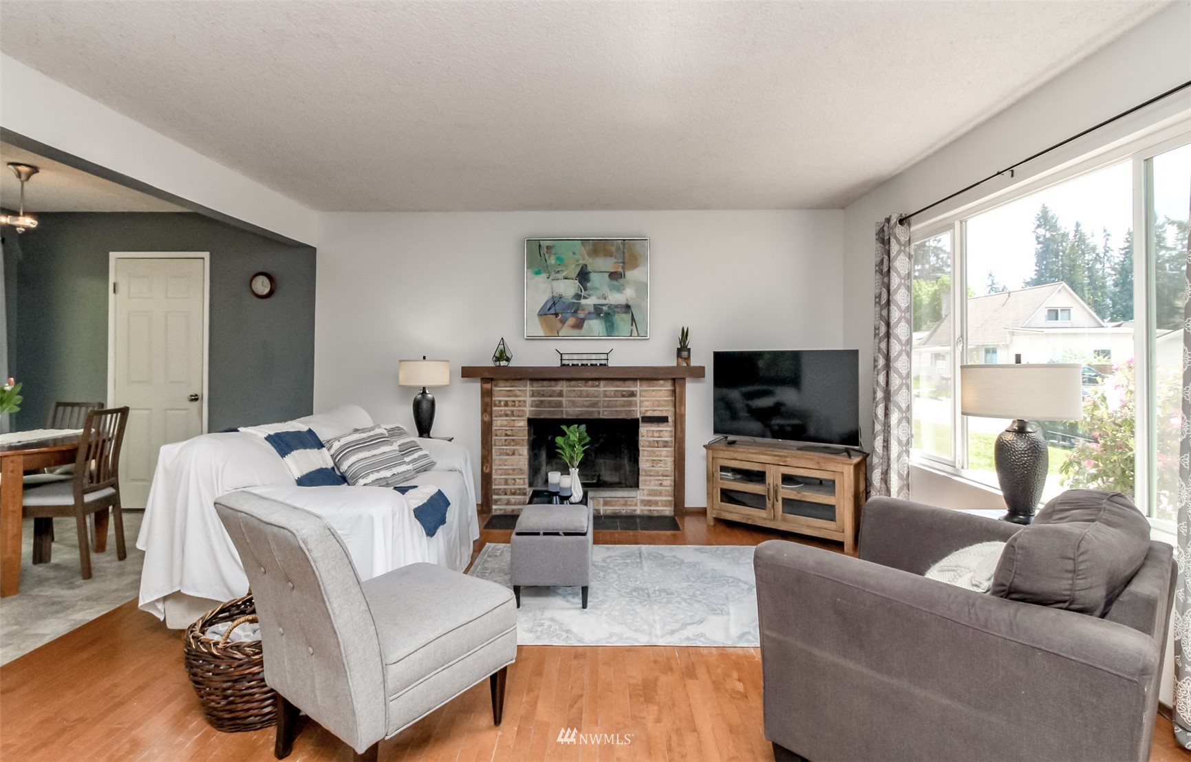 14604 Southeast 140th Place Renton, WA 98059 - Photo 4 of 28 a living room with furniture a flat screen tv and a fireplace