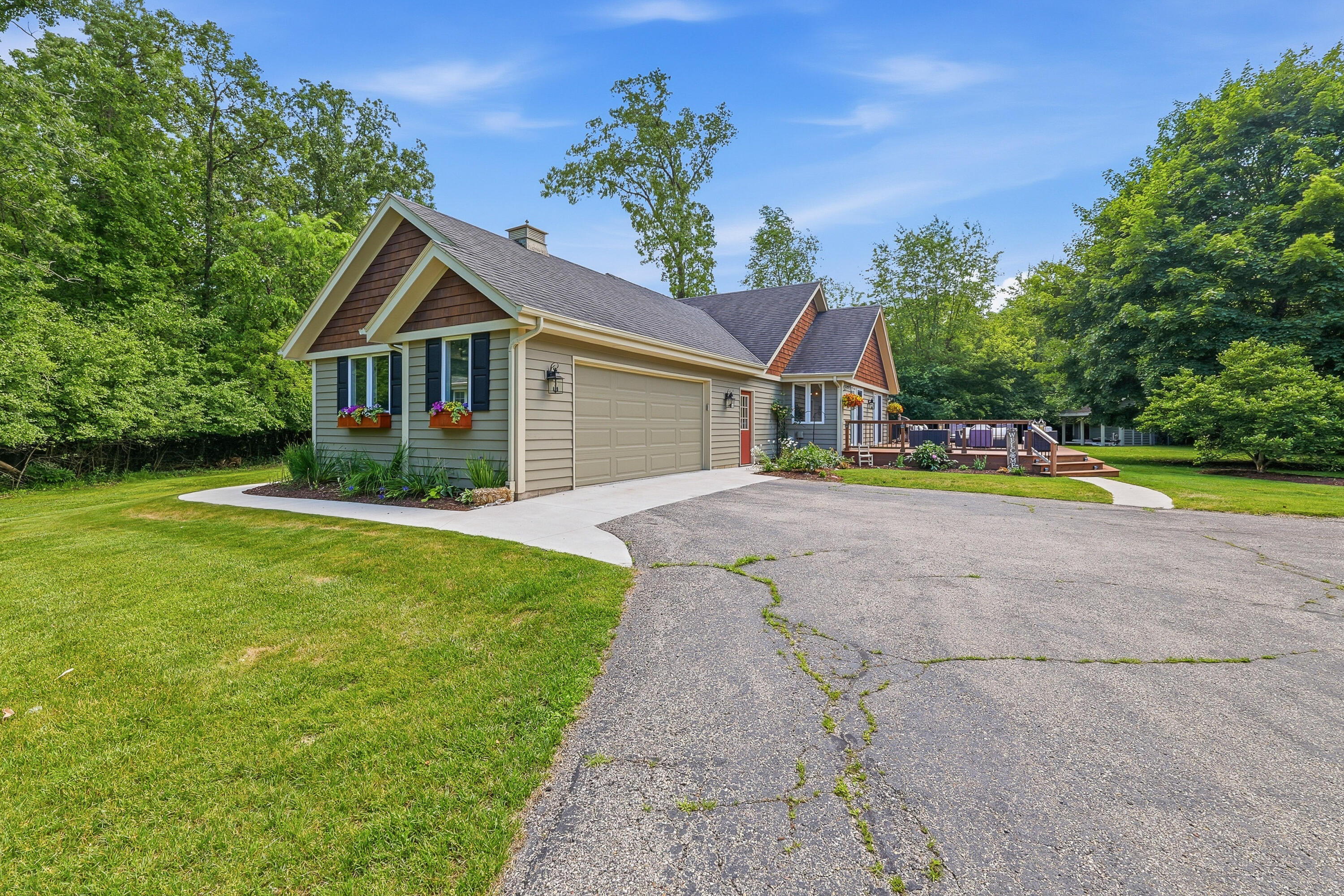 34899 Pabst Road Summit, WI 53066 - Photo 33 of 38 Size: 25'W x 21'D Attached garage features a utility sink, utility window for natural light, service door, and convenient access into the mudroom area.