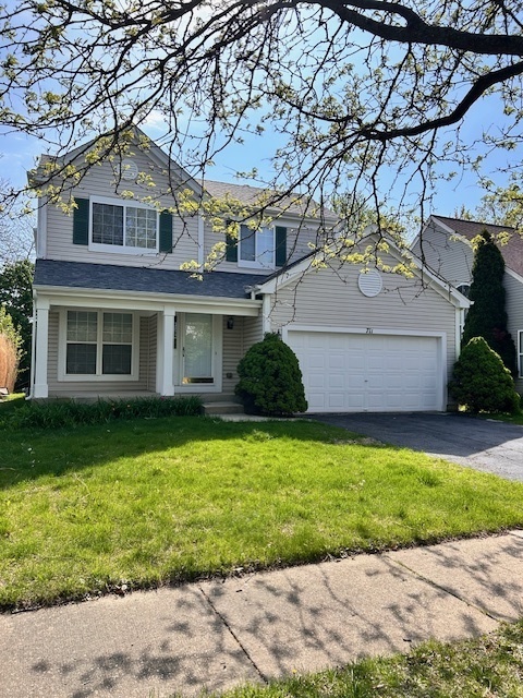 711 Violet Circle Naperville, IL 60540 - Photo 1 of 21 a front view of a house with a garden