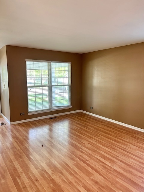 711 Violet Circle Naperville, IL 60540 - Photo 2 of 21 a view of empty room with wooden floor and fan