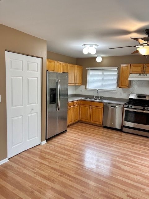 711 Violet Circle Naperville, IL 60540 - Photo 6 of 21 a view of kitchen with sink and wooden floor