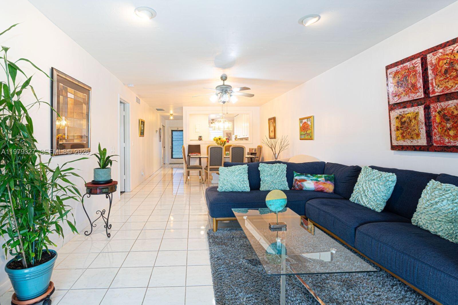 1421 Northwest 19th Terrace, Unit 102 Delray Beach, FL 33445 - Photo 15 of 30 a living room with furniture and a potted plant