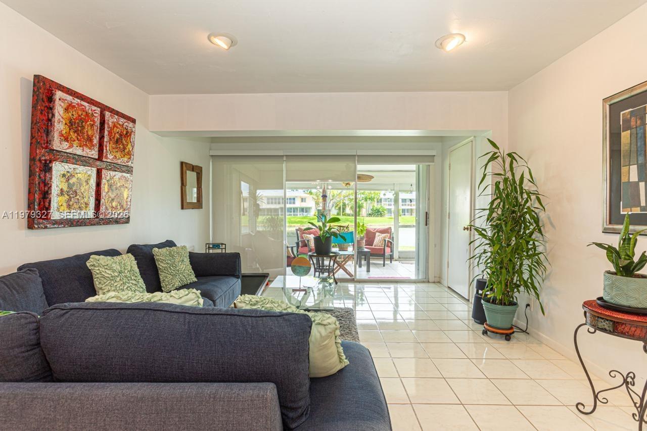 1421 Northwest 19th Terrace, Unit 102 Delray Beach, FL 33445 - Photo 17 of 30 a living room with furniture and a potted plant