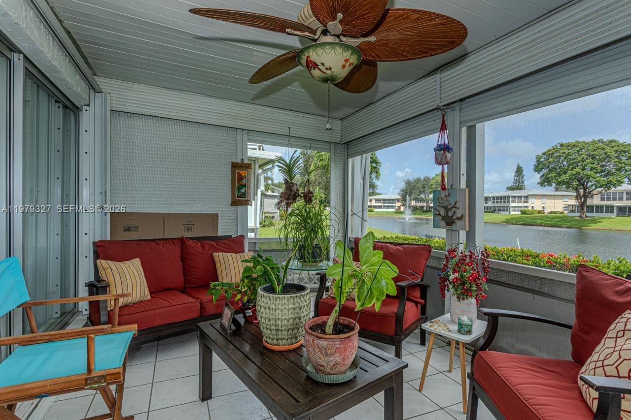 1421 Northwest 19th Terrace, Unit 102 Delray Beach, FL 33445 - Photo 19 of 30 a outdoor living space with furniture and a garden