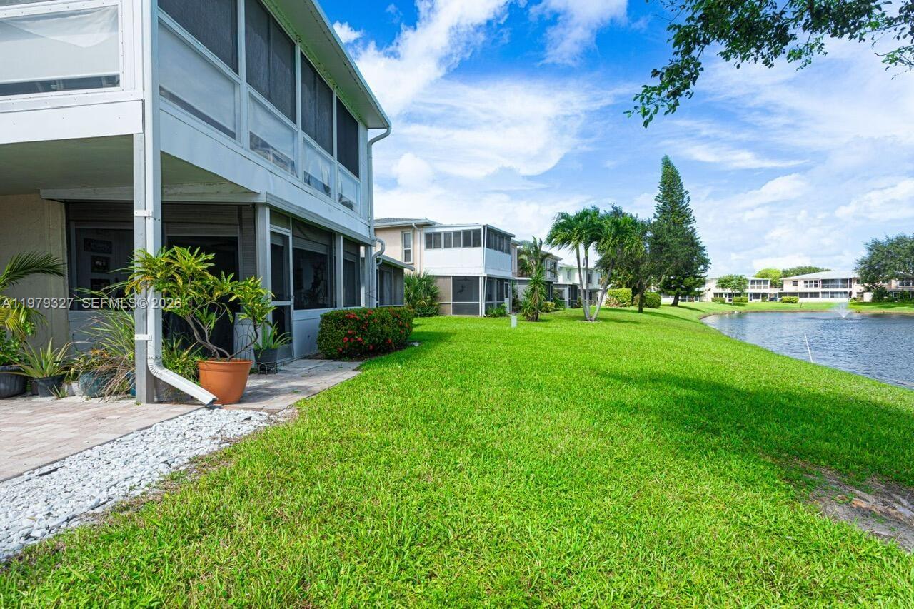 1421 Northwest 19th Terrace, Unit 102 Delray Beach, FL 33445 - Photo 22 of 30 a view of a house with a garden