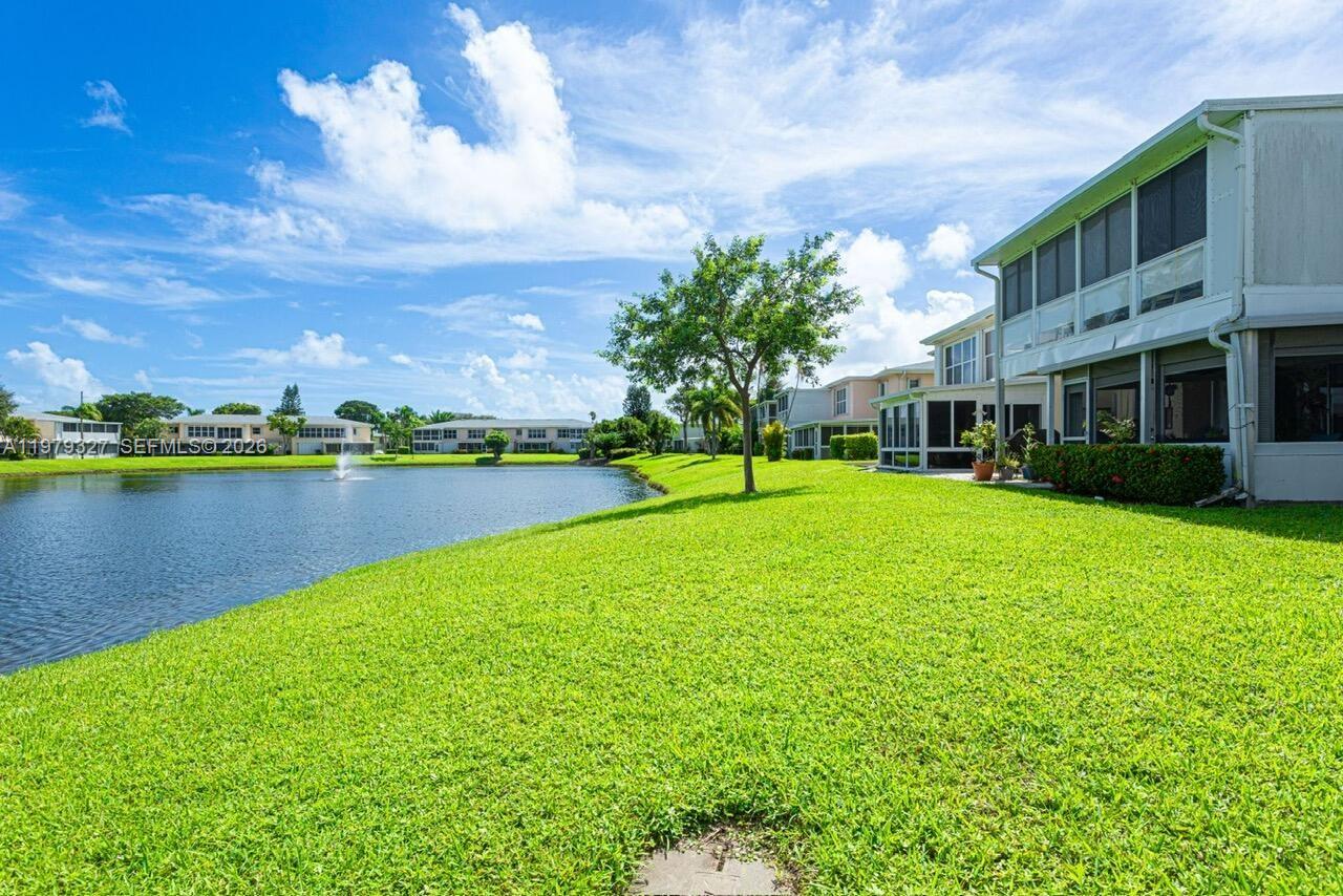 1421 Northwest 19th Terrace, Unit 102 Delray Beach, FL 33445 - Photo 23 of 30 a view of a lake with a building in the background