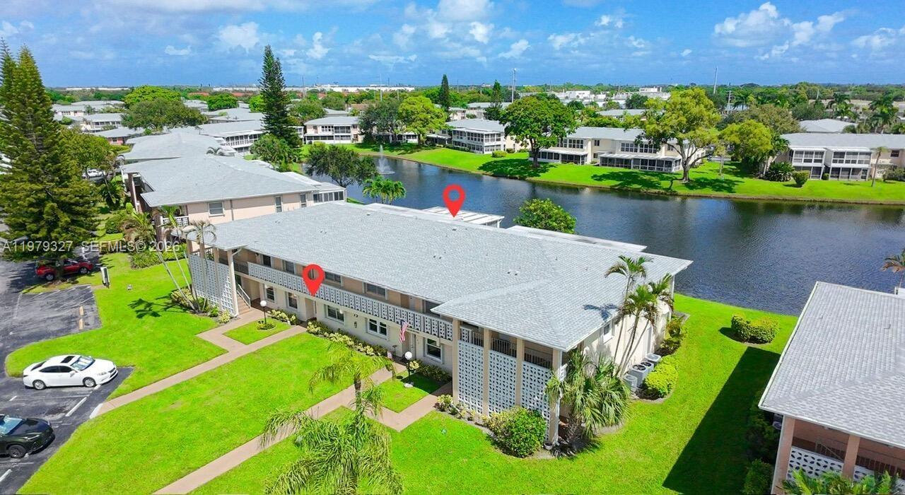 1421 Northwest 19th Terrace, Unit 102 Delray Beach, FL 33445 - Photo 25 of 30 an aerial view of a house with a garden and lake view