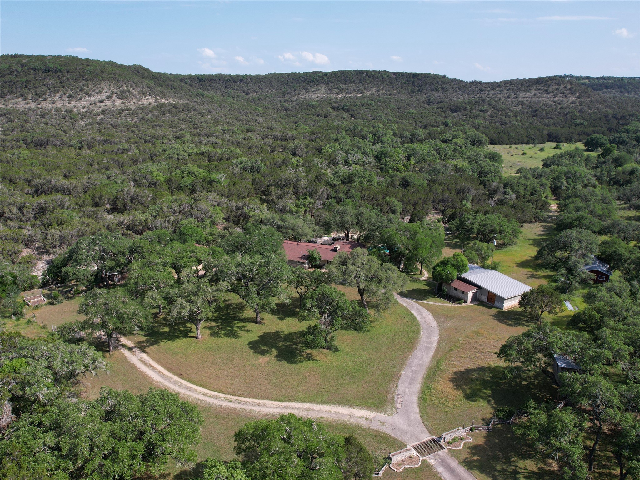 an aerial view of green landscape with trees houses and mountain view