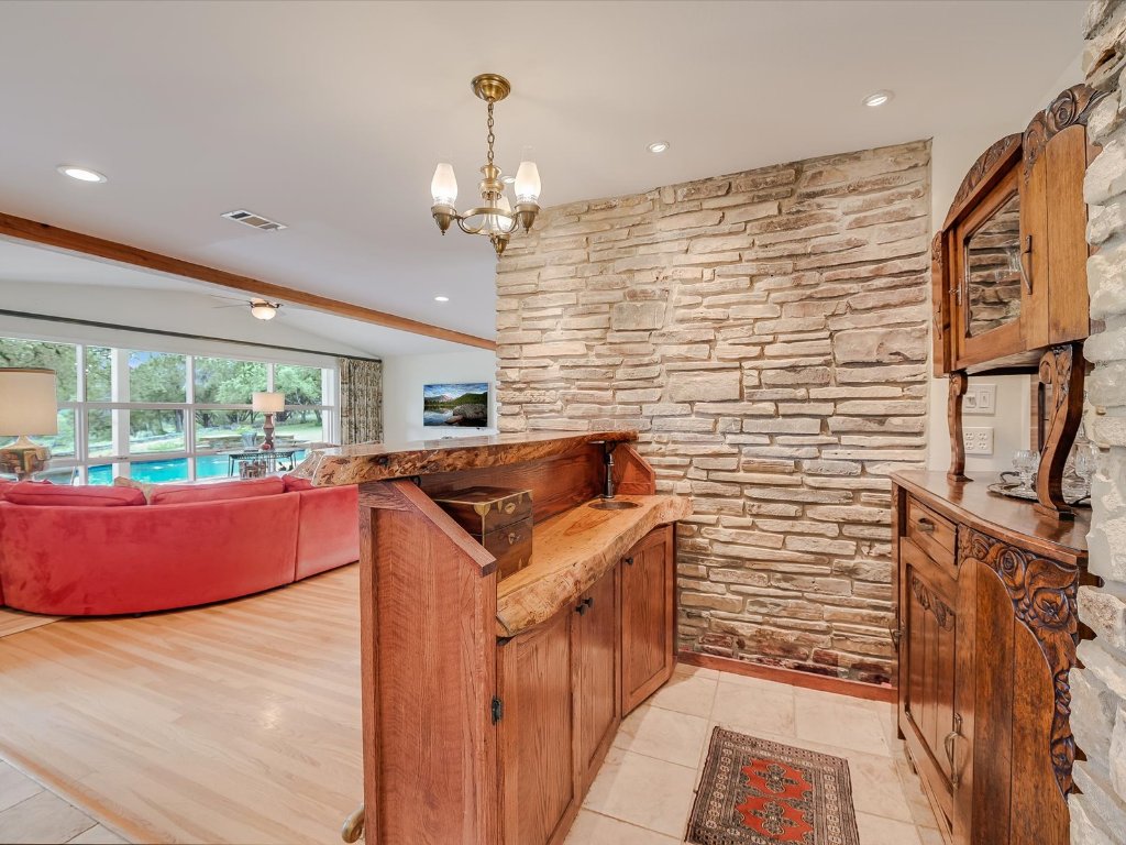 1500 Spoke Hollow Road Wimberley, TX 78676 - Photo 11 of 39 a room with stainless steel appliances kitchen island granite countertop furniture and a large window