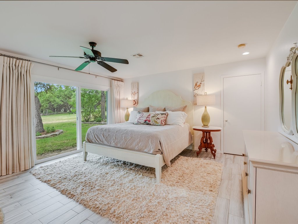 1500 Spoke Hollow Road Wimberley, TX 78676 - Photo 15 of 39 a bedroom with a bed and a window