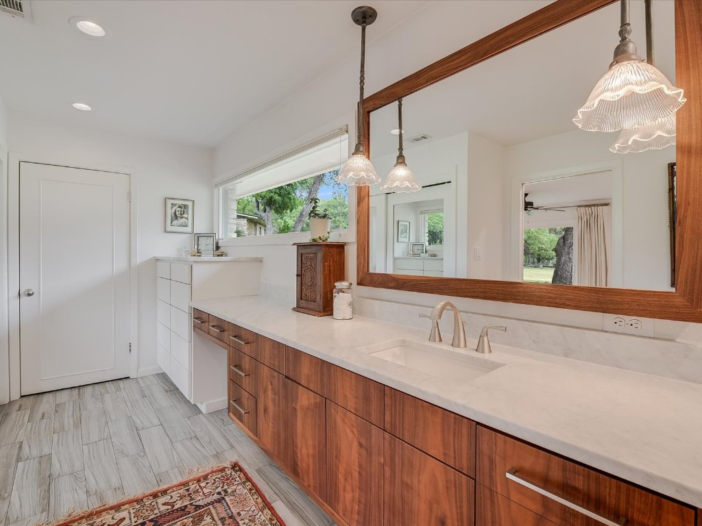 1500 Spoke Hollow Road Wimberley, TX 78676 - Photo 18 of 39 a bathroom with a double vanity sink and a mirror