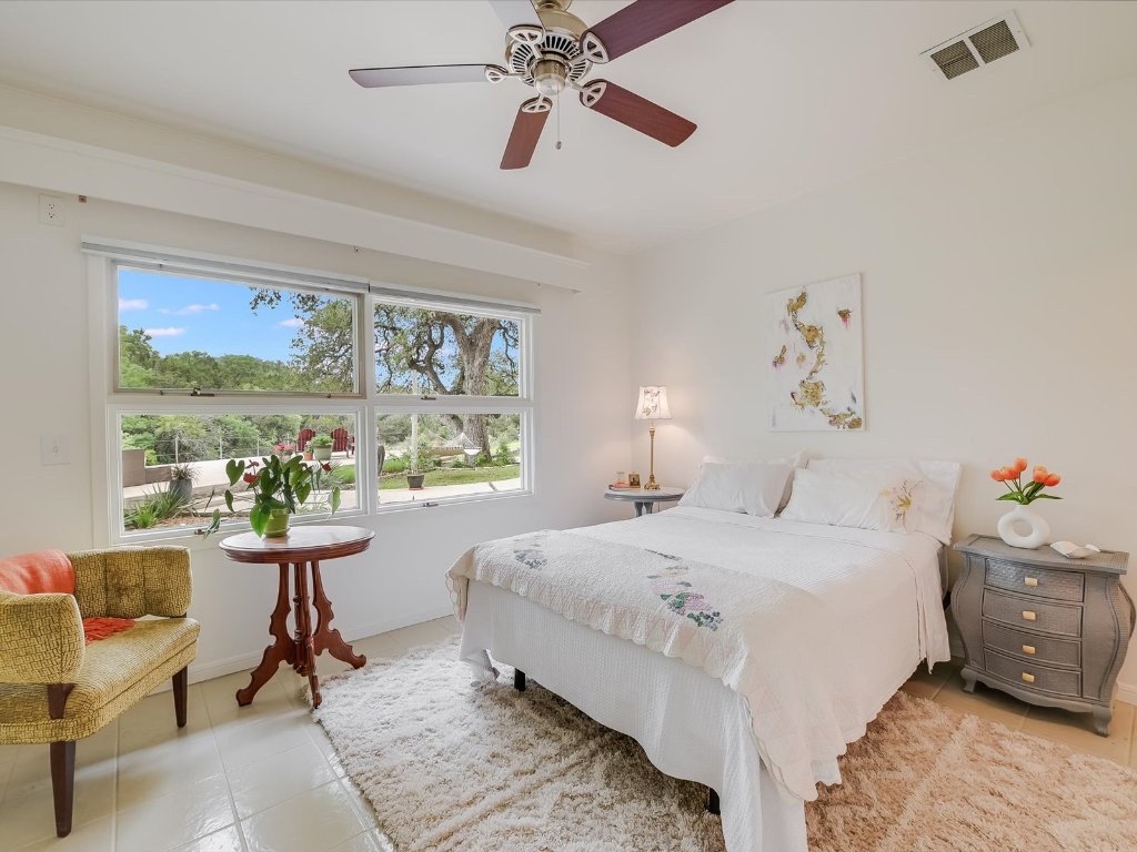 1500 Spoke Hollow Road Wimberley, TX 78676 - Photo 22 of 39 a bedroom with a bed and a large window