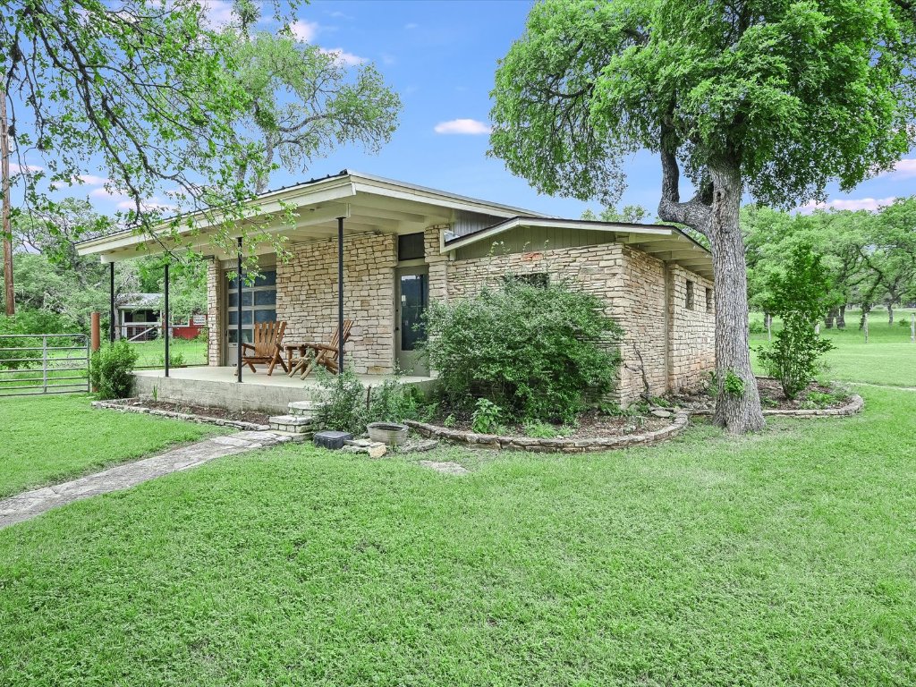 1500 Spoke Hollow Road Wimberley, TX 78676 - Photo 25 of 39 front view of a house with a yard