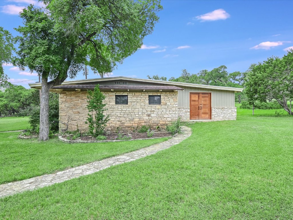 1500 Spoke Hollow Road Wimberley, TX 78676 - Photo 26 of 39 a front view of house with yard and green space