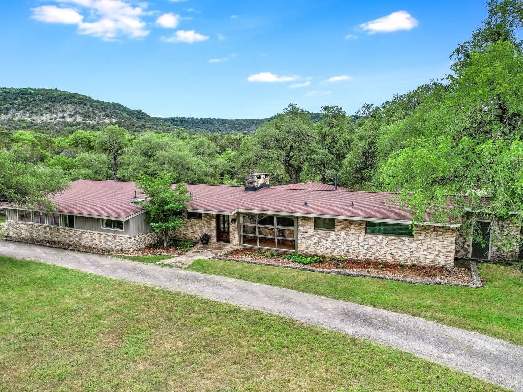 1500 Spoke Hollow Road Wimberley, TX 78676 - Photo 3 of 39 a view of a yard with a house in the background