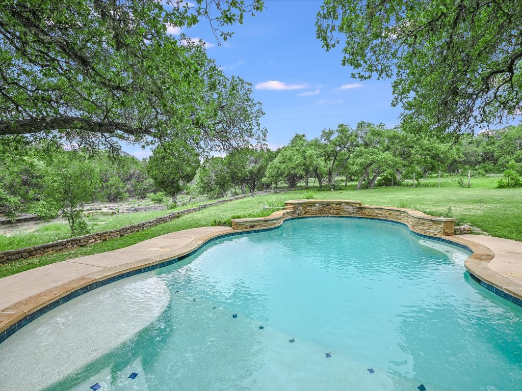 1500 Spoke Hollow Road Wimberley, TX 78676 - Photo 31 of 39 a view of a swimming pool and a yard
